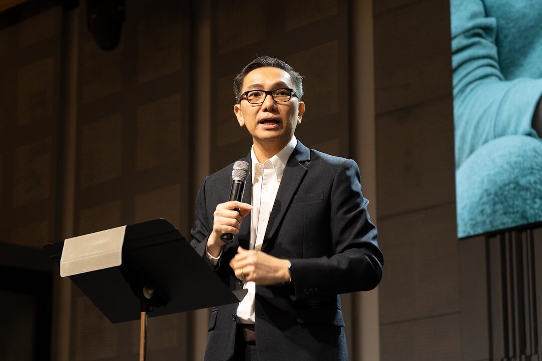 Speaker presenting to an audience at a business conference