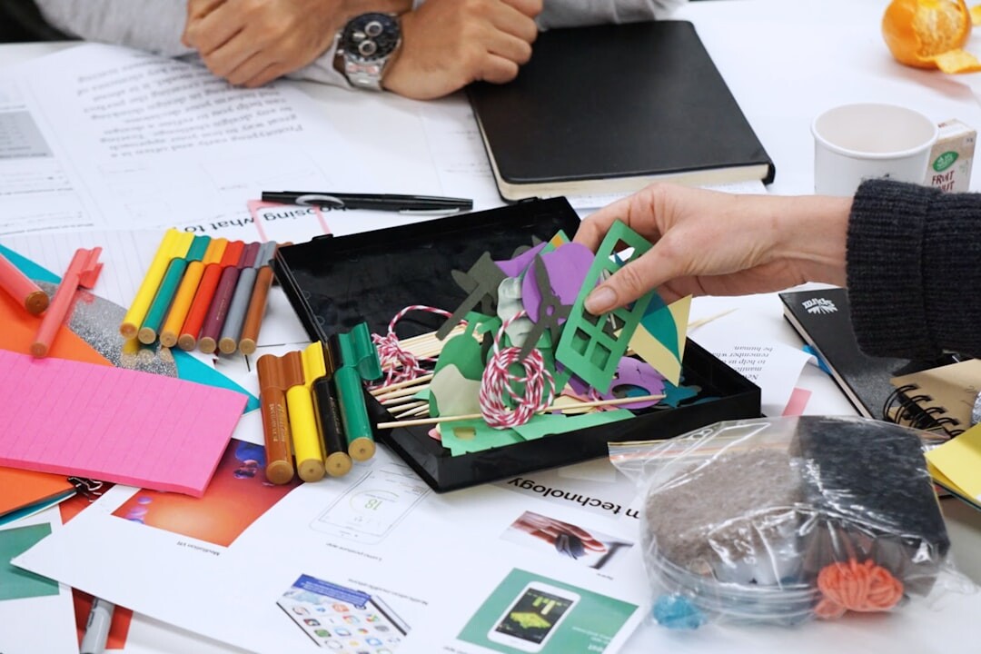 Colleagues collaborating at a workshop table with laptops and notes